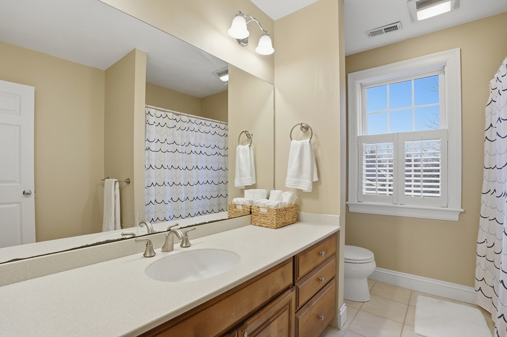 531 Salisbury Street Worcester, MA 01609 - Photo 31 of 42 a bathroom with a double vanity sink toilet and a mirror