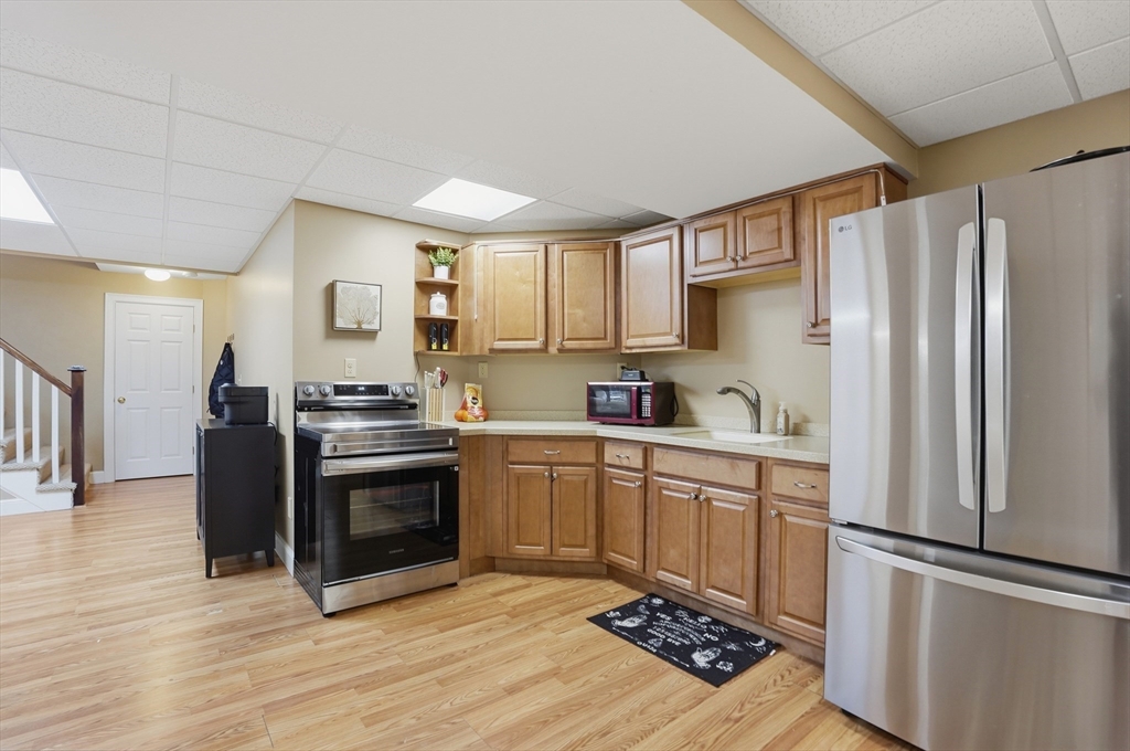 531 Salisbury Street Worcester, MA 01609 - Photo 34 of 42 a kitchen with stainless steel appliances granite countertop a refrigerator stove sink and cabinets