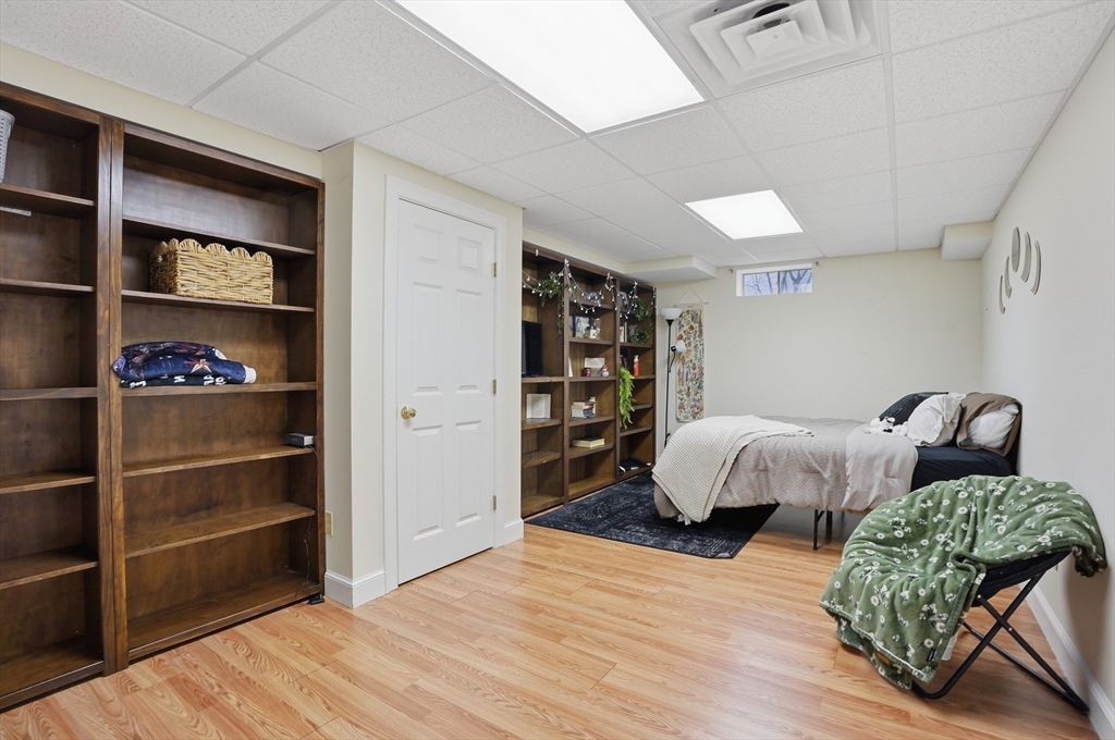 531 Salisbury Street Worcester, MA 01609 - Photo 36 of 42 a bedroom with furniture and a book shelf