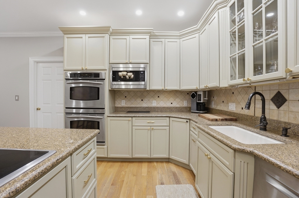 531 Salisbury Street Worcester, MA 01609 - Photo 6 of 42 a kitchen with stainless steel appliances granite countertop a kitchen island a stove a sink and white cabinets