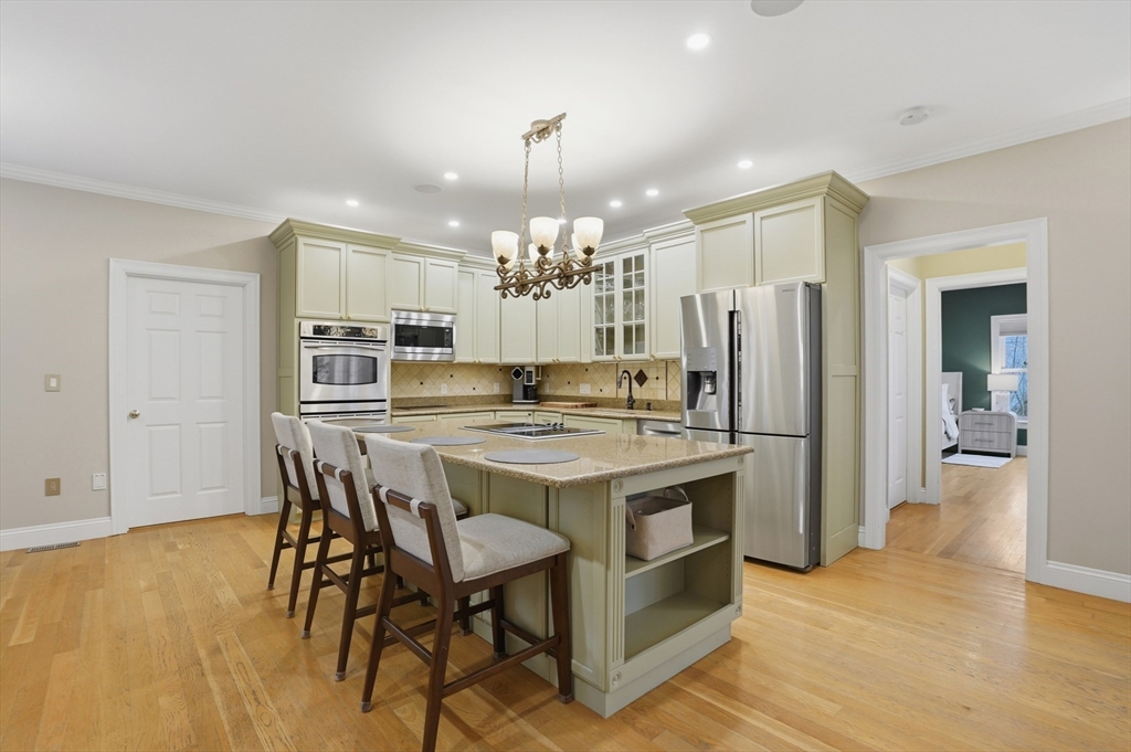 531 Salisbury Street Worcester, MA 01609 - Photo 7 of 42 a kitchen with stainless steel appliances a dining table chairs and chandelier