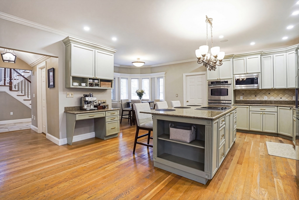 531 Salisbury Street Worcester, MA 01609 - Photo 8 of 42 a kitchen with kitchen island granite countertop a sink cabinets and stainless steel appliances