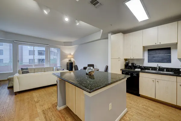 a kitchen with granite countertop a sink and a stove