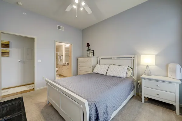 a bedroom with a bed and a night stand