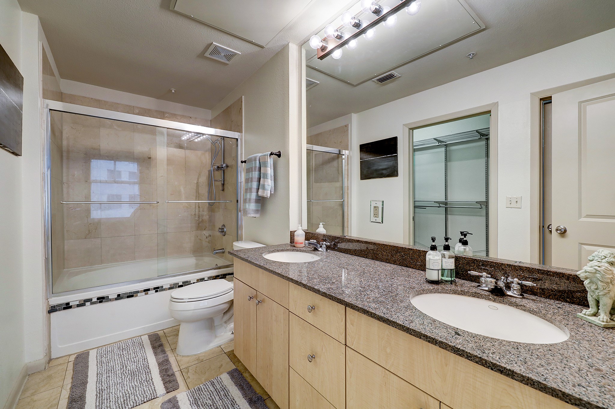 3505 Sage Road, Unit 308 Houston, TX 77056 - Photo 13 of 20 a bathroom with a granite countertop sink toilet mirror and shower