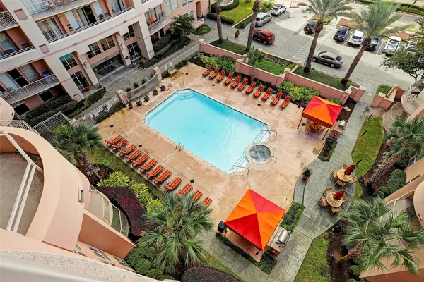 an aerial view of a pool patio outdoor seating and outdoor kitchen front