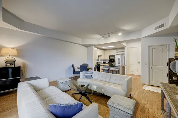 a living room with furniture and a wooden floor
