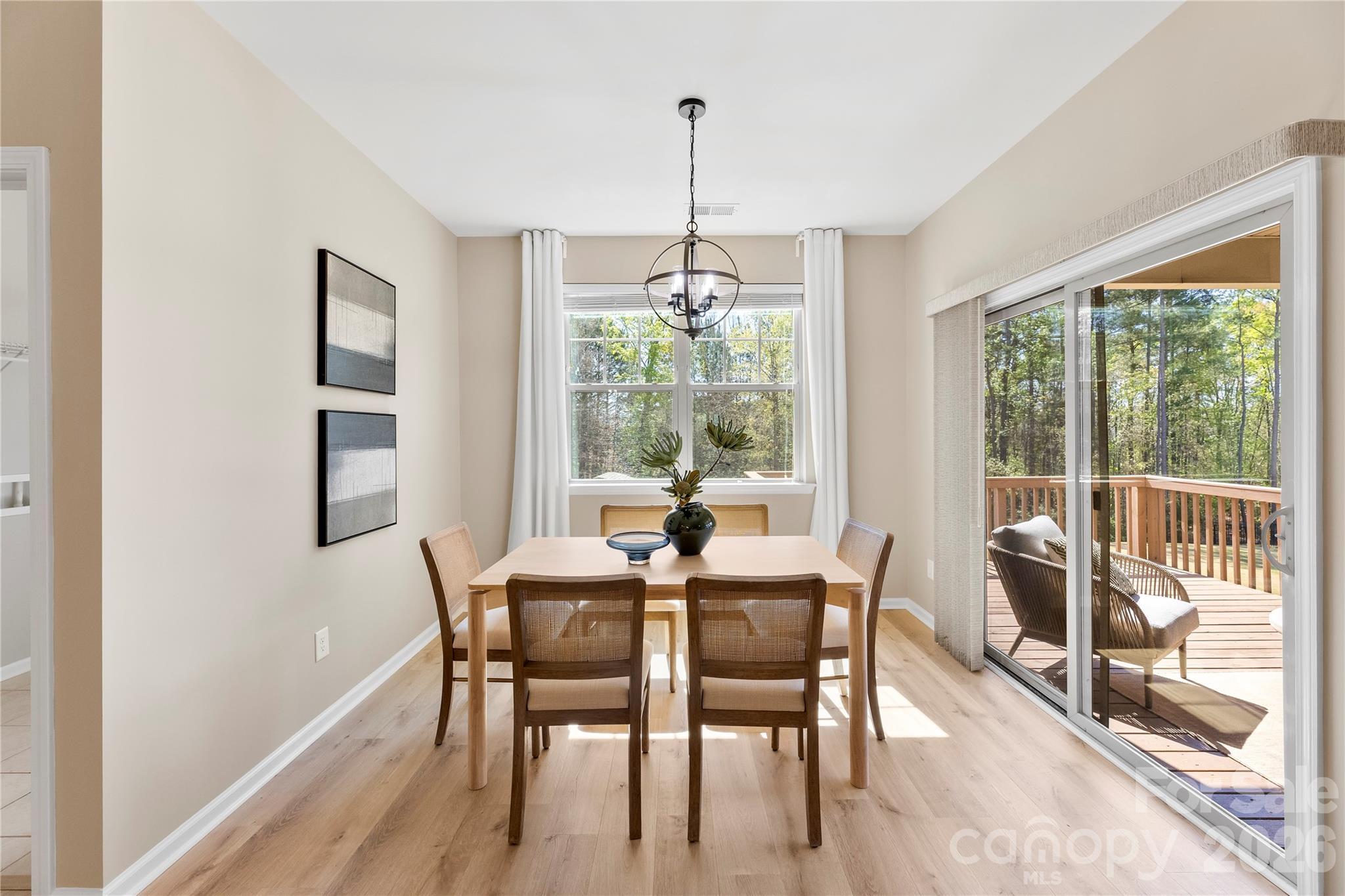 834 Spelman Drive Fort Mill, SC 29707 - Photo 12 of 48 a dining room with furniture large windows and a chandelier