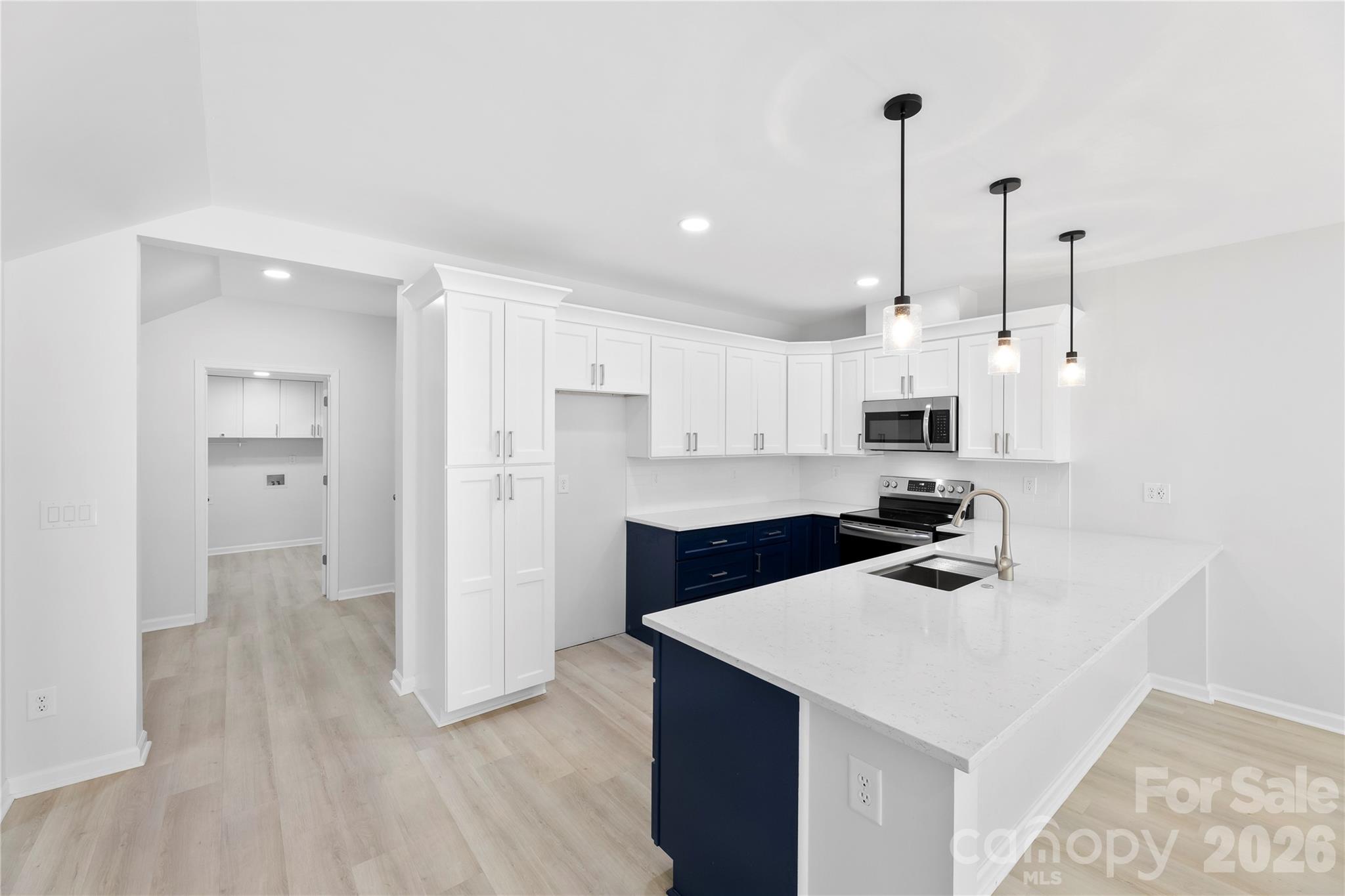 834 Spelman Drive Fort Mill, SC 29707 - Photo 26 of 48 a kitchen with stainless steel appliances a stove a sink a refrigerator and white cabinets