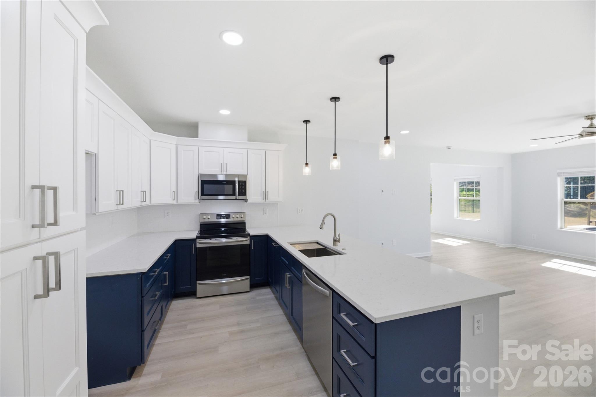834 Spelman Drive Fort Mill, SC 29707 - Photo 27 of 48 a kitchen with granite countertop a sink and stove
