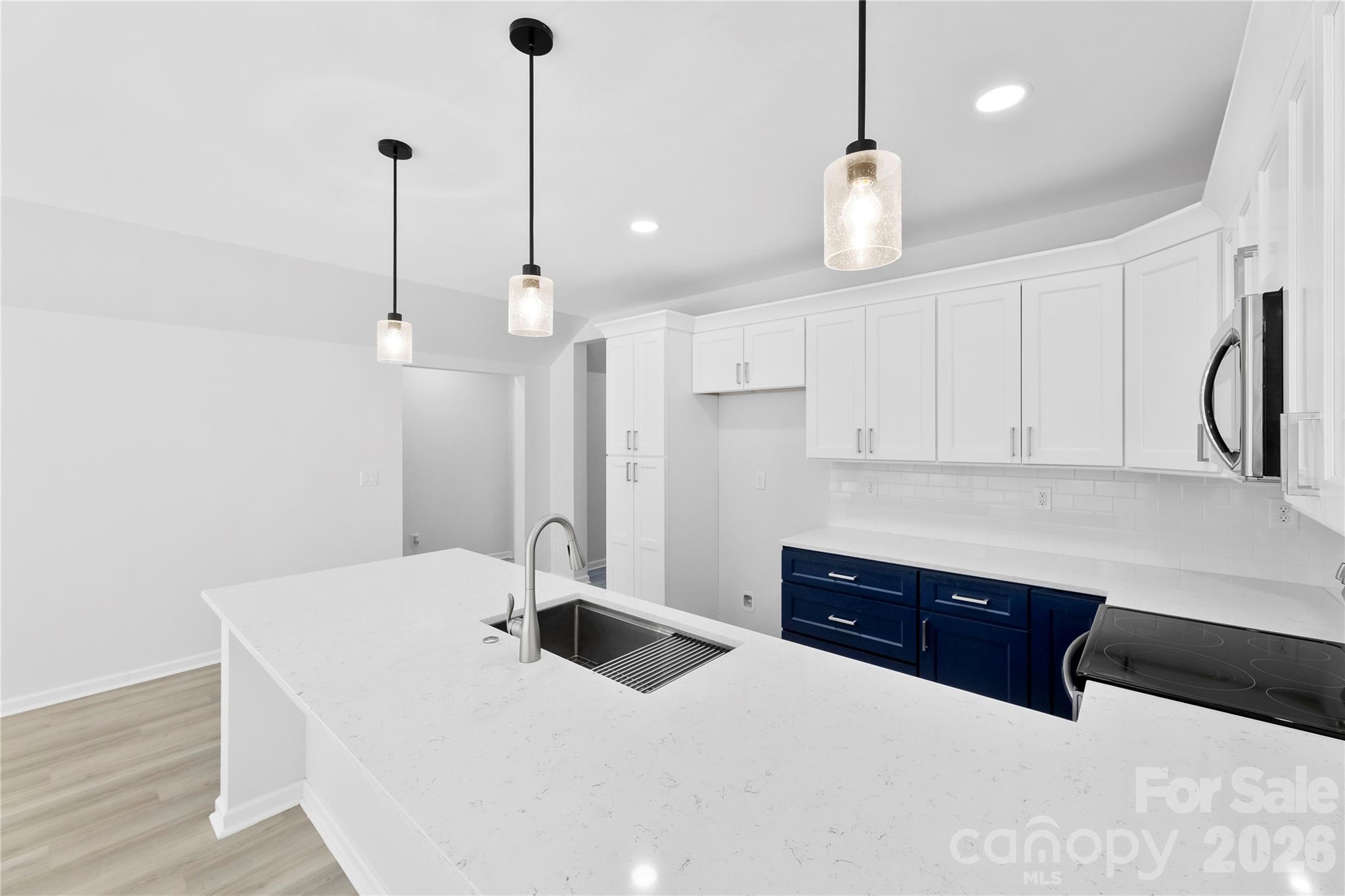 834 Spelman Drive Fort Mill, SC 29707 - Photo 28 of 48 a kitchen with stainless steel appliances kitchen island granite countertop a sink a microwave and cabinets