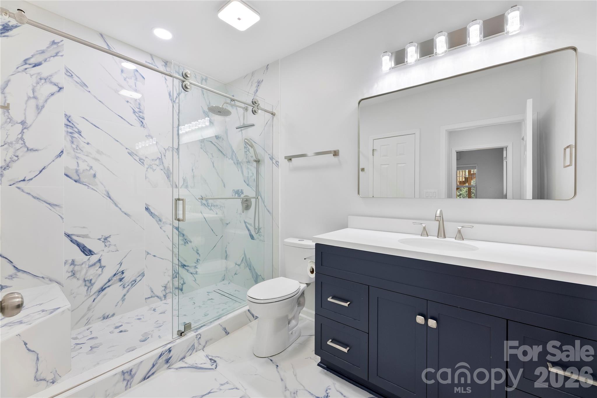 834 Spelman Drive Fort Mill, SC 29707 - Photo 32 of 48 a bathroom with a sink toilet a mirror and shower