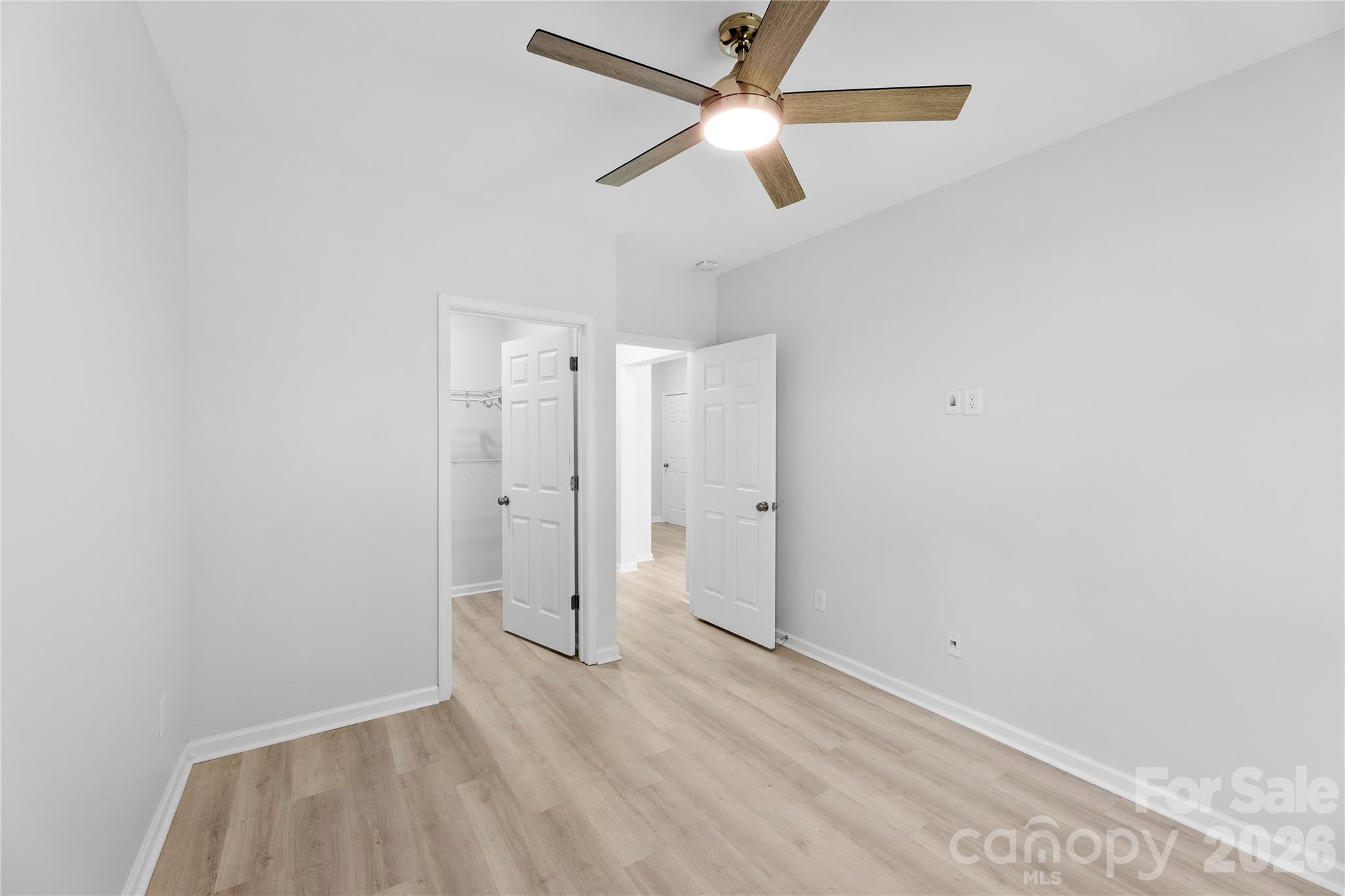 834 Spelman Drive Fort Mill, SC 29707 - Photo 35 of 48 an empty room with closet and a ceiling fan