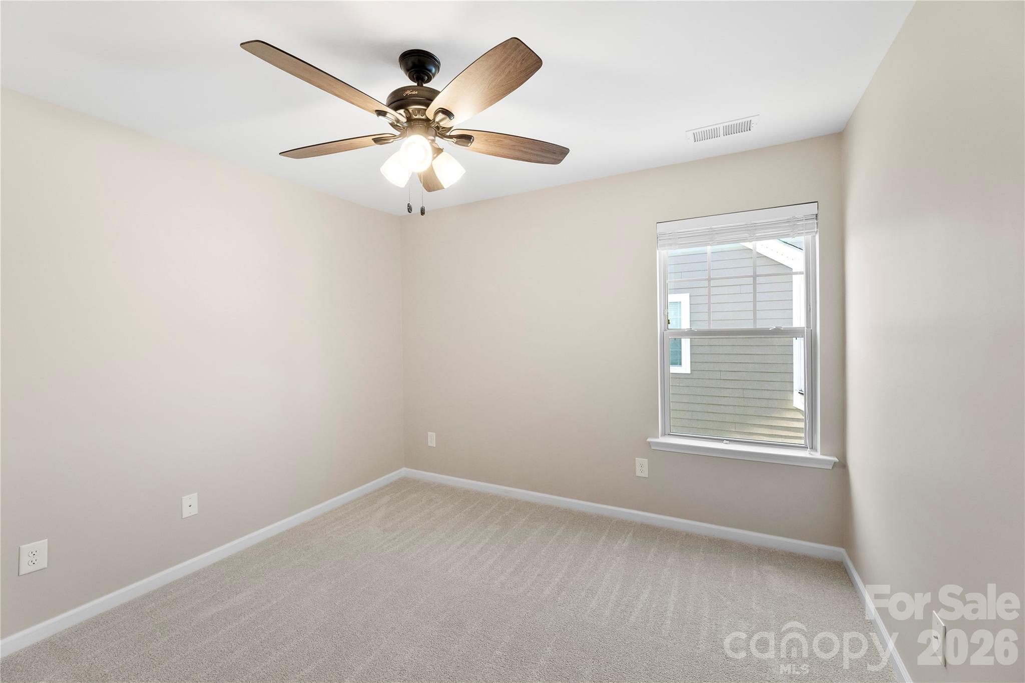834 Spelman Drive Fort Mill, SC 29707 - Photo 42 of 48 an empty room with a window and a fan