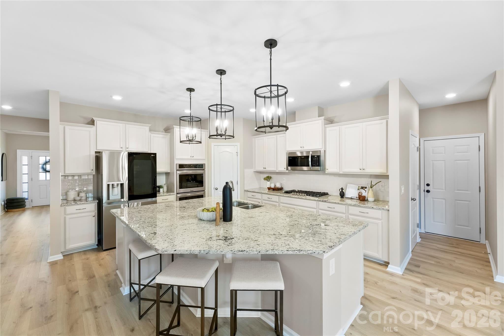 834 Spelman Drive Fort Mill, SC 29707 - Photo 7 of 48 a kitchen with kitchen island granite countertop a table and chairs in it