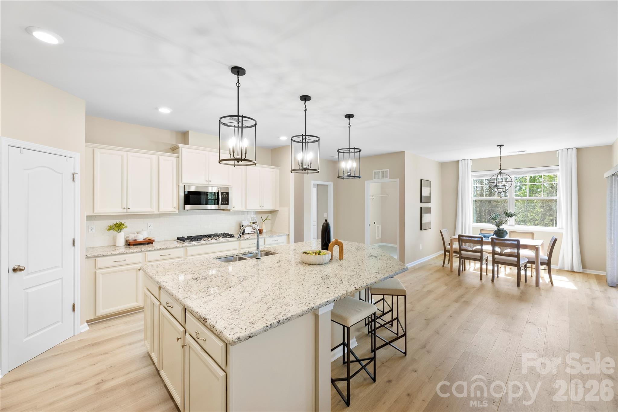 834 Spelman Drive Fort Mill, SC 29707 - Photo 8 of 48 a kitchen with granite countertop cabinets countertop stainless steel appliances and dining table
