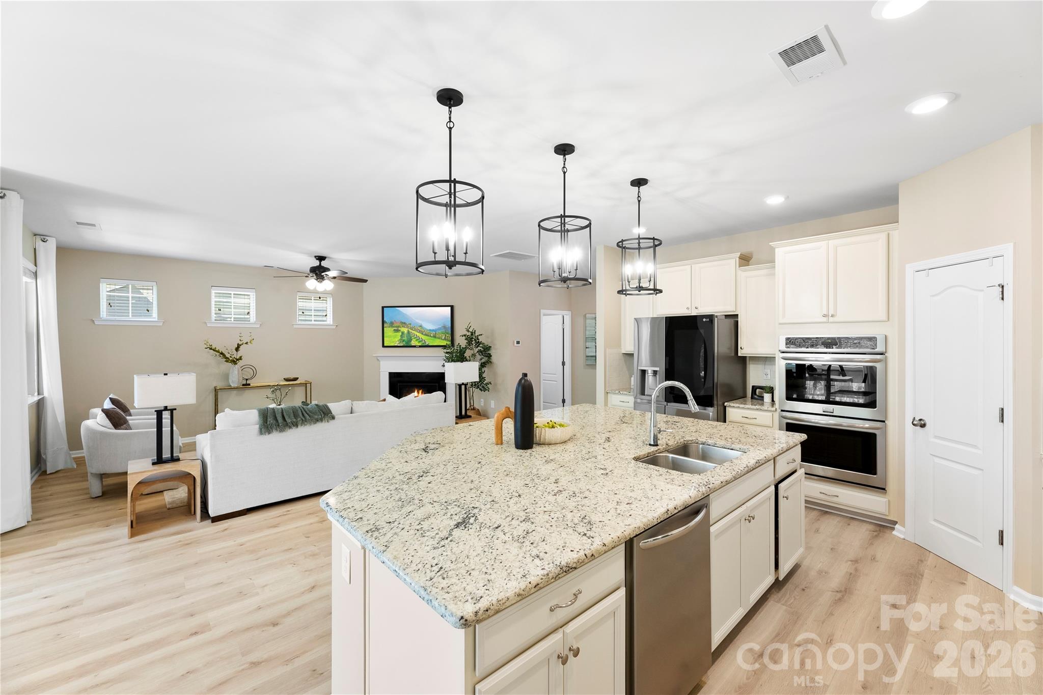 834 Spelman Drive Fort Mill, SC 29707 - Photo 9 of 48 a kitchen with stainless steel appliances kitchen island granite countertop a sink and cabinets