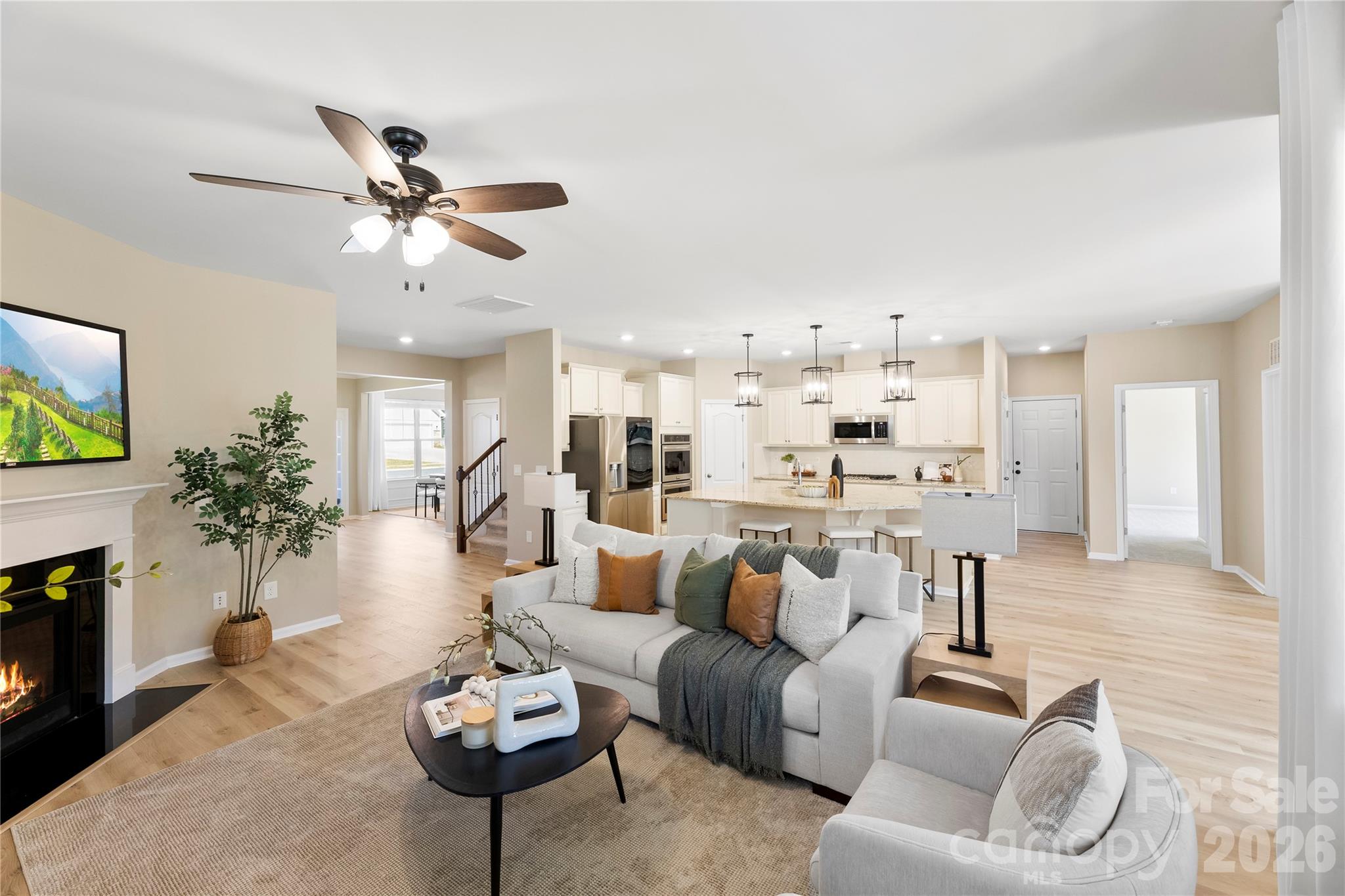 834 Spelman Drive Fort Mill, SC 29707 - Photo 10 of 48 a living room with furniture kitchen view and a fireplace