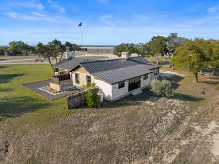 an aerial view of a house with a big yard