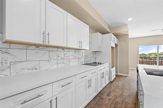 a kitchen with a sink stove and cabinets