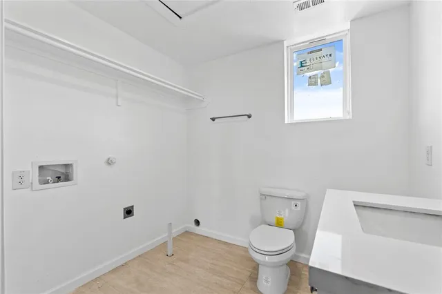 a bathroom with a toilet and a sink