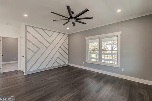 a view of a hallway with wooden floor and stairs