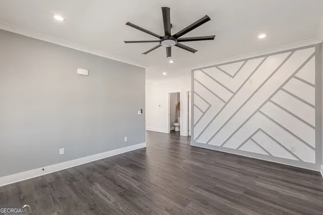 a view of a hallway with wooden floor and kitchen