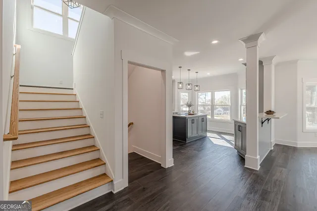 a kitchen with cabinets appliances a sink and a window