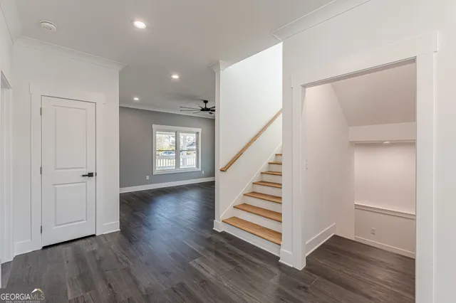 a kitchen with refrigerator cabinets and wooden floor