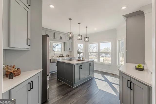 a kitchen with a sink stove and wooden floor