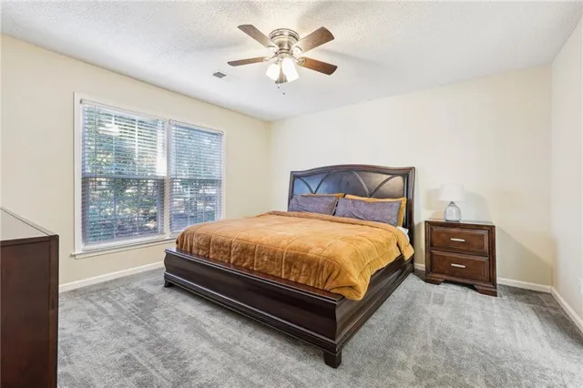 a bed sitting in a bedroom next to a window