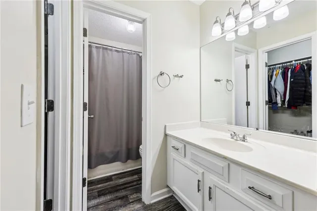 a bathroom with a sink vanity and shower