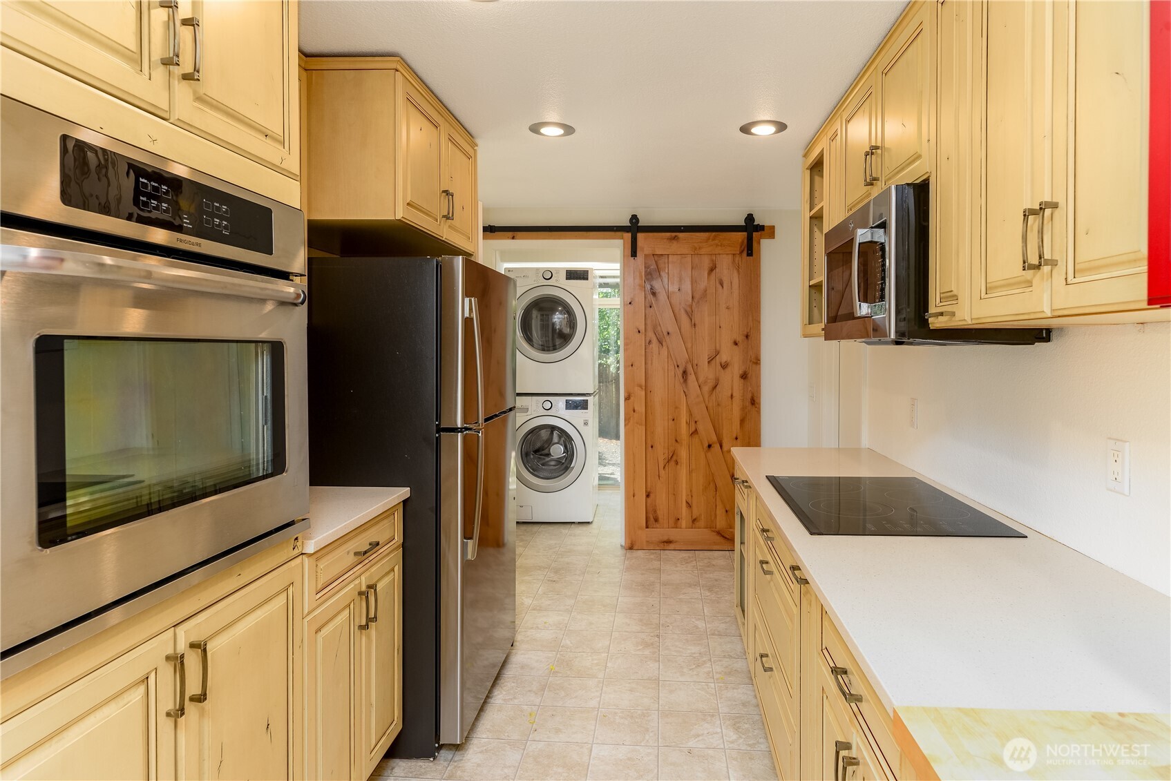 179 Hurricane Ridge Drive Sequim, WA 98382 - Photo 16 of 34 a kitchen with a refrigerator and a stove