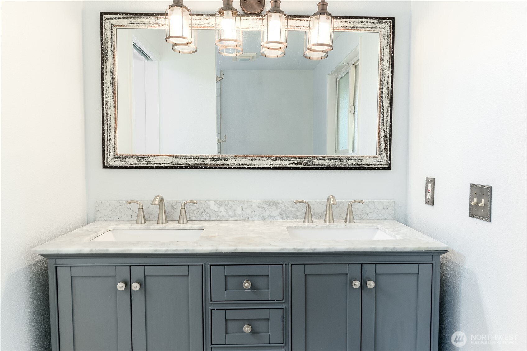 179 Hurricane Ridge Drive Sequim, WA 98382 - Photo 27 of 34 a bathroom with a sink vanity and a mirror