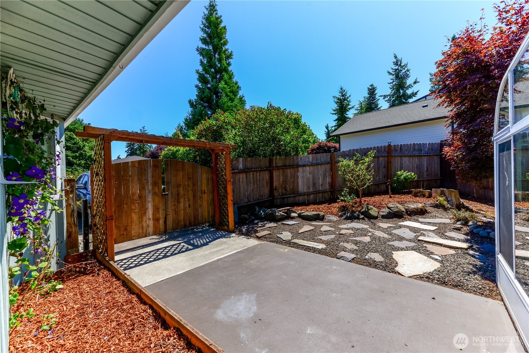 179 Hurricane Ridge Drive Sequim, WA 98382 - Photo 7 of 34 a view of a backyard with a patio