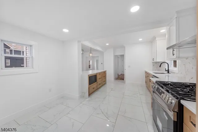 a kitchen with stainless steel appliances a stove a sink and a refrigerator