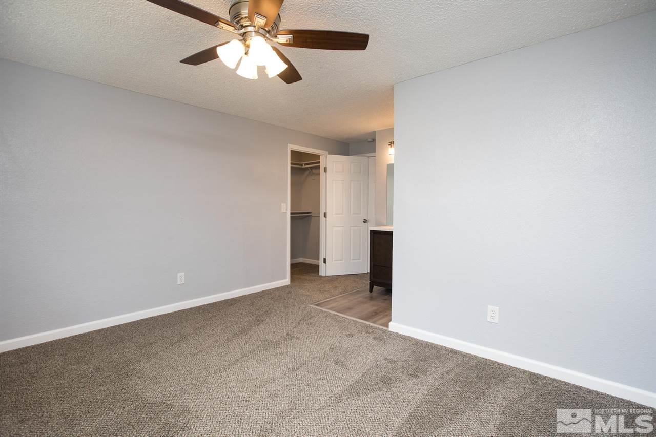 14075 Perlite Drive Reno, NV 89521 - Photo 12 of 25 an empty room with closet and a chandelier fan