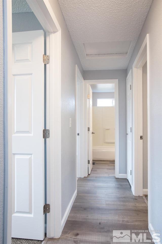 14075 Perlite Drive Reno, NV 89521 - Photo 19 of 25 a view of a hallway with wooden floor and closet area