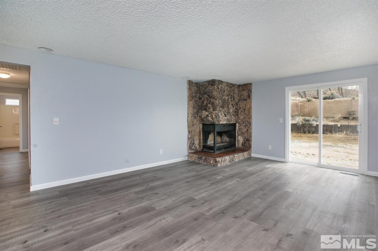 14075 Perlite Drive Reno, NV 89521 - Photo 3 of 25 wooden floor fireplace and natural light in room