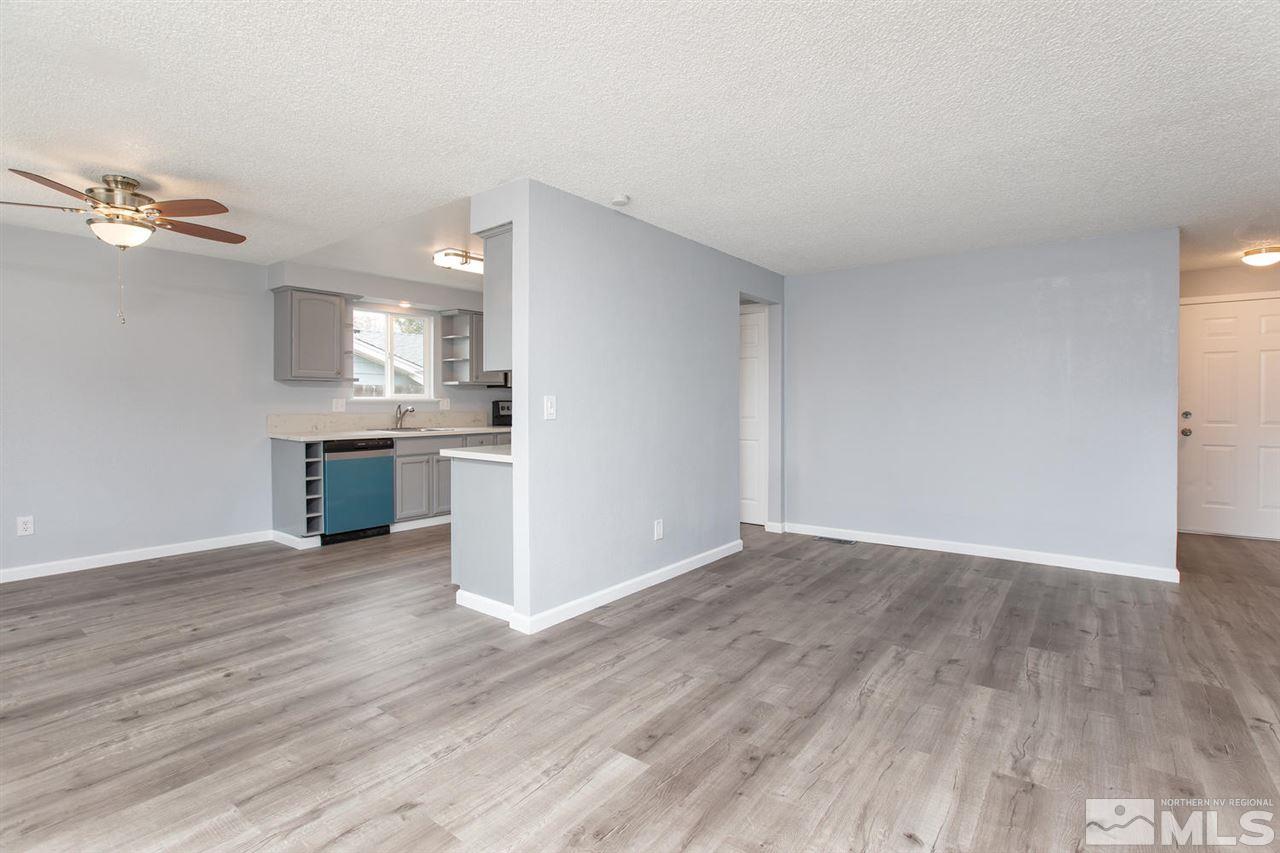 14075 Perlite Drive Reno, NV 89521 - Photo 5 of 25 an empty room with wooden floor and cabinet