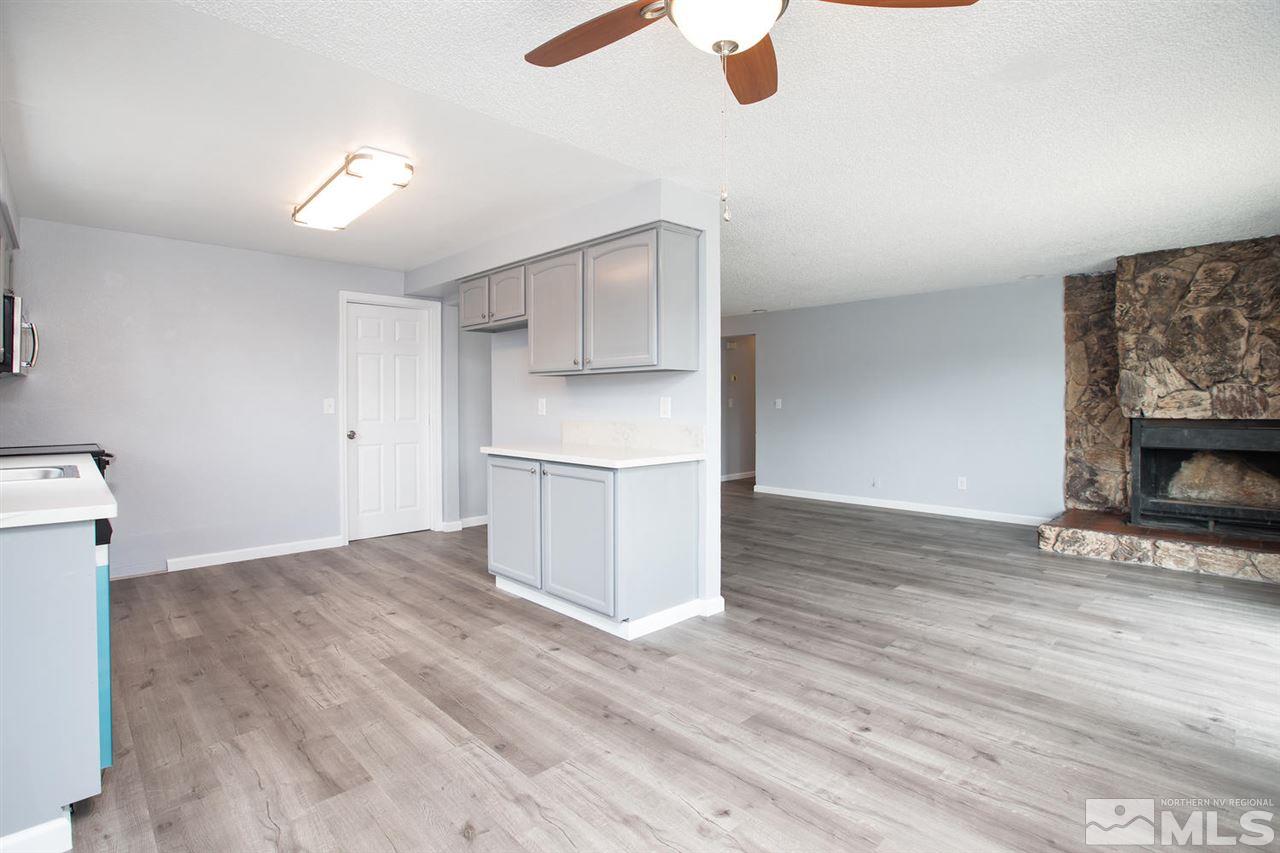 14075 Perlite Drive Reno, NV 89521 - Photo 6 of 25 a view of kitchen and empty room with wooden floor