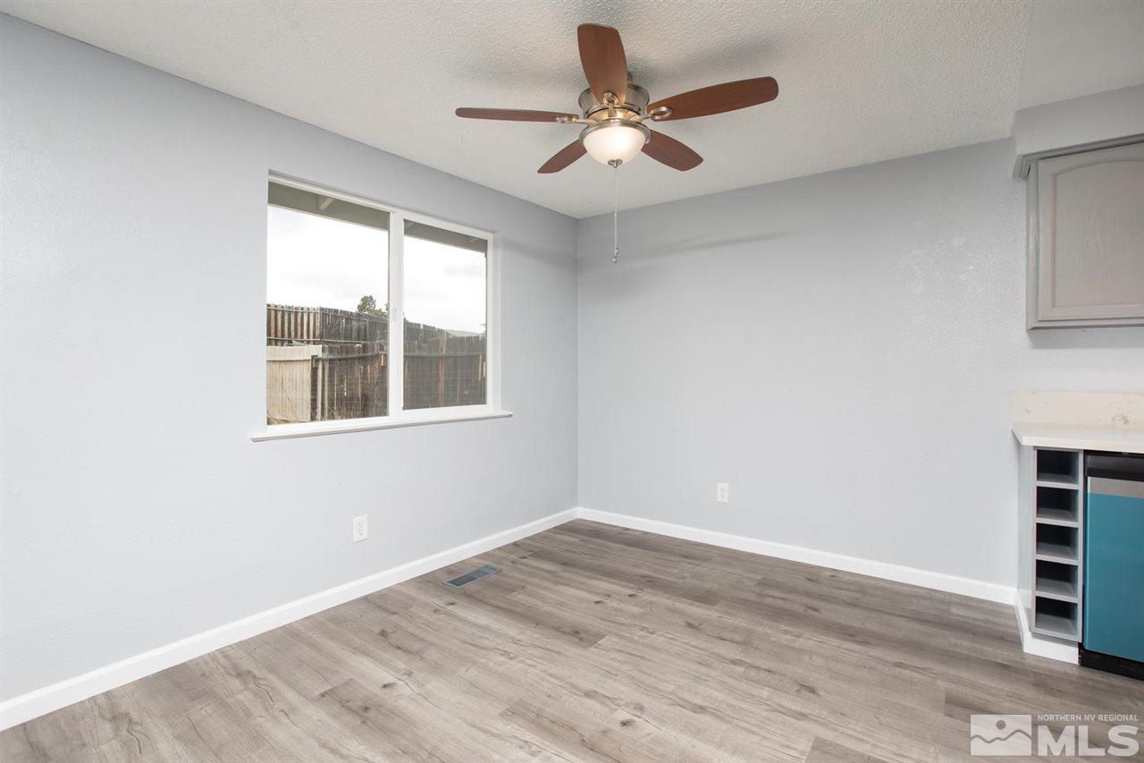 14075 Perlite Drive Reno, NV 89521 - Photo 7 of 25 an empty room with wooden floor and windows