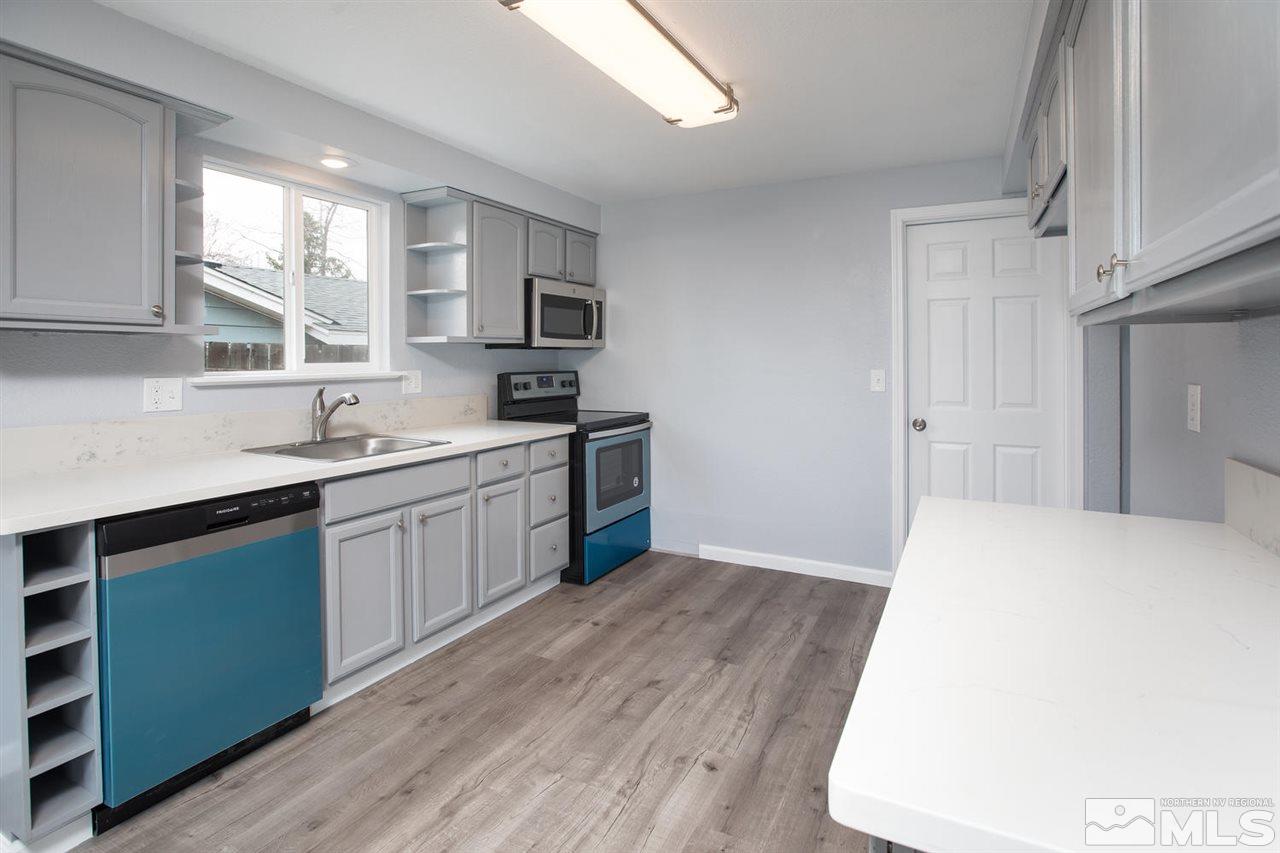 14075 Perlite Drive Reno, NV 89521 - Photo 9 of 25 a kitchen with a sink a window and cabinets