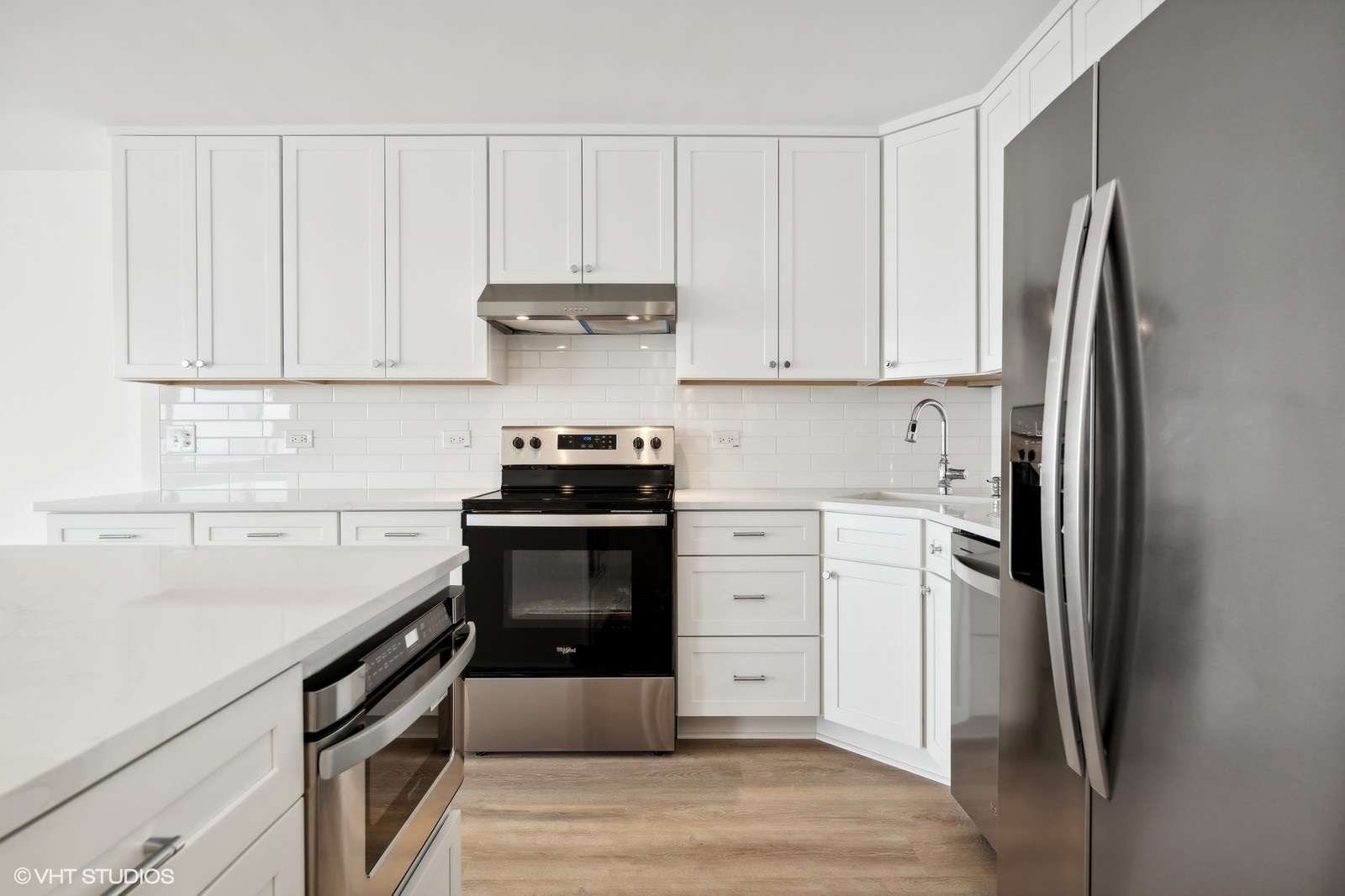 1500 Sheridan Road, Unit 4J Wilmette, IL 60091 - Photo 9 of 24 a kitchen with a refrigerator and white cabinets