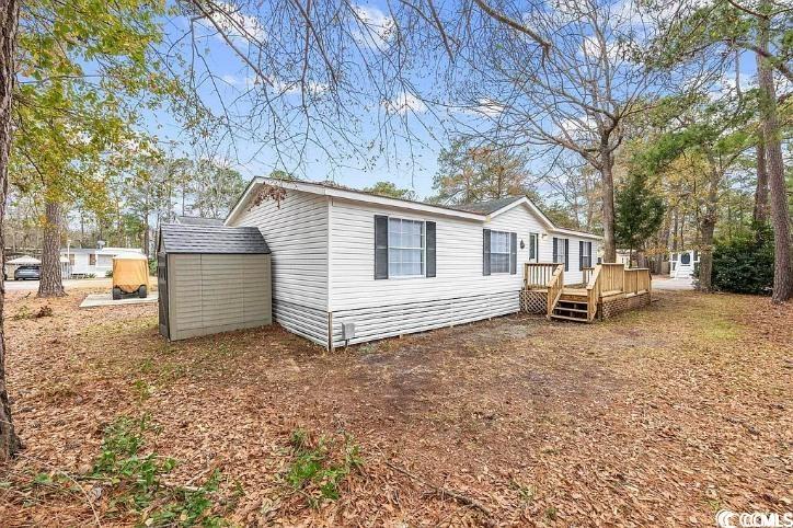 46 Islander Court Murrells Inlet, SC 29576 - Photo 1 of 14 Rear view of property featuring a storage shed and