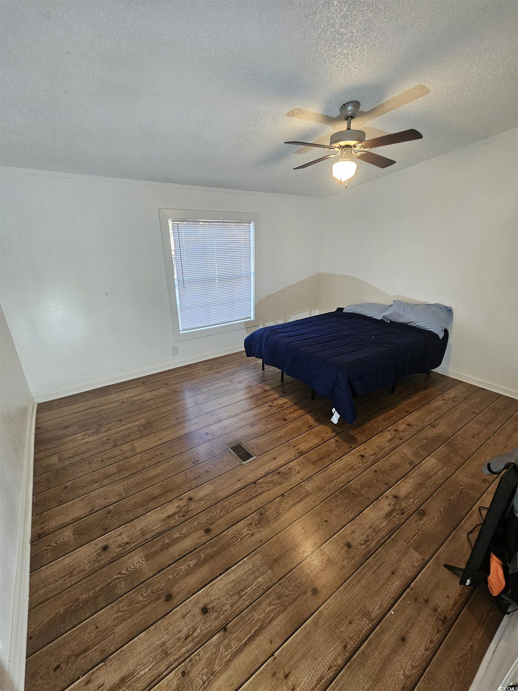 46 Islander Court Murrells Inlet, SC 29576 - Photo 7 of 14 Unfurnished bedroom with ceiling fan, dark hardwoo