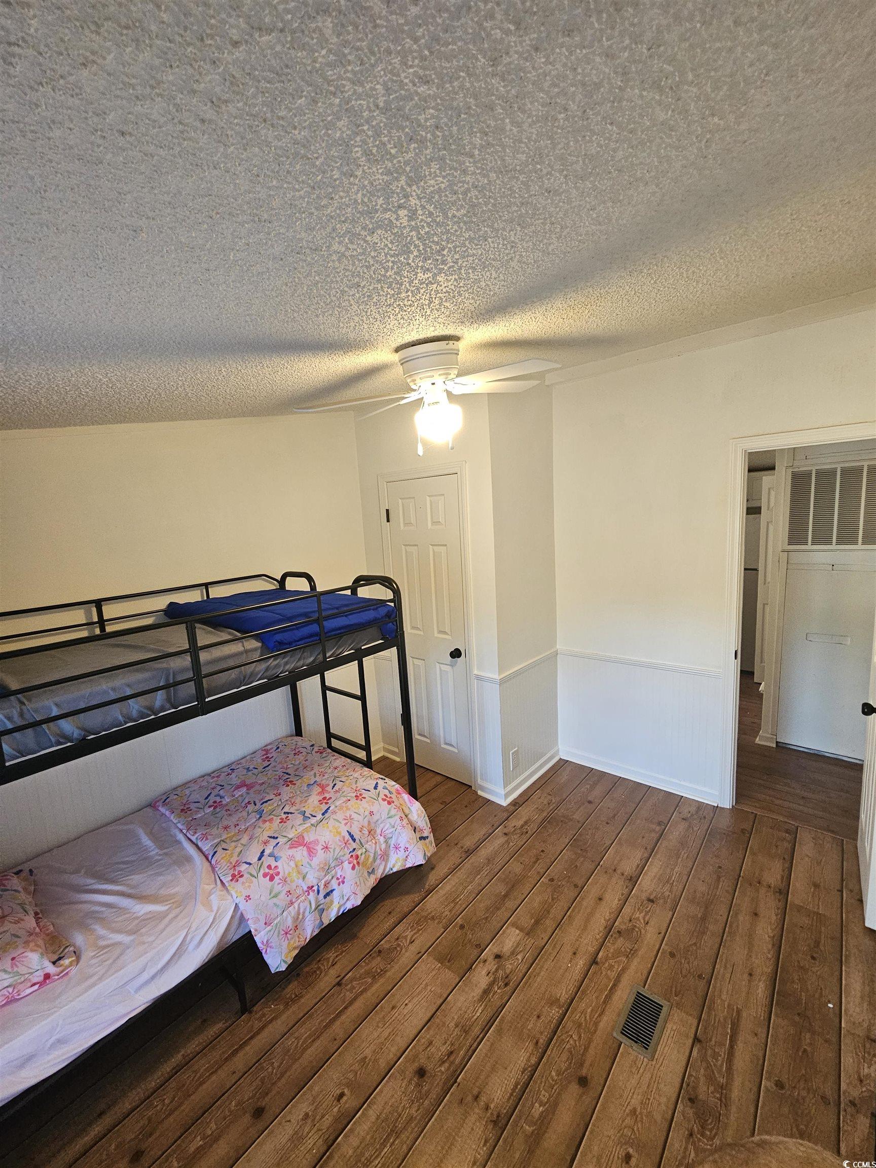 46 Islander Court Murrells Inlet, SC 29576 - Photo 10 of 14 Bedroom with a textured ceiling, dark hardwood / w