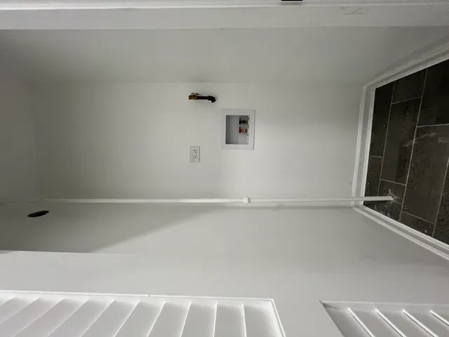 a view of water heater room with stairs