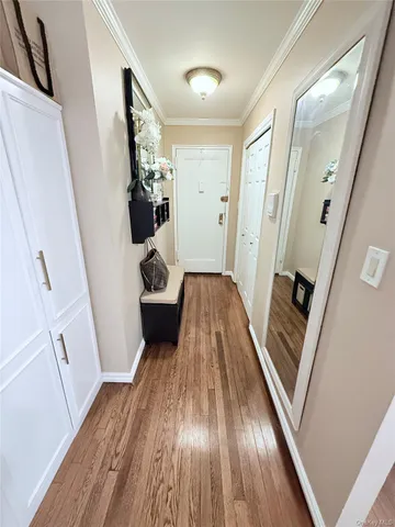 a view of a hallway view with wooden floor and staircase