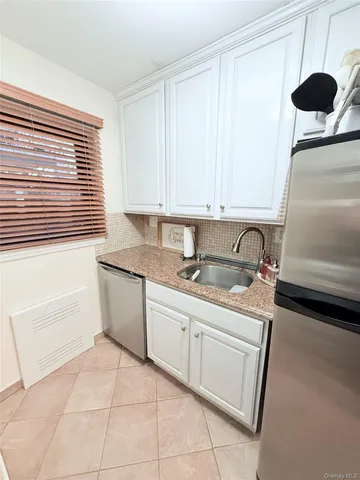 a kitchen with a sink and a stove top oven